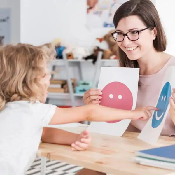 Child engaging in an autism therapy session with a therapist